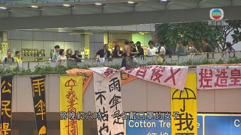 金鐘佔領區女子爬出海富天橋欄杆懸掛標語